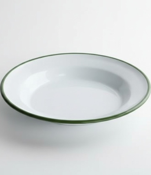 A simple yet elegant white plate with a dark green rim, embodying the charm of nostalgic enamelware, presented on a bright white background.